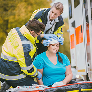 Paramedics treating an injured woman by an ambulance after an accident Personal Injury Recovery Process After An Auto Wreck - Porter & Guidry Law Firm